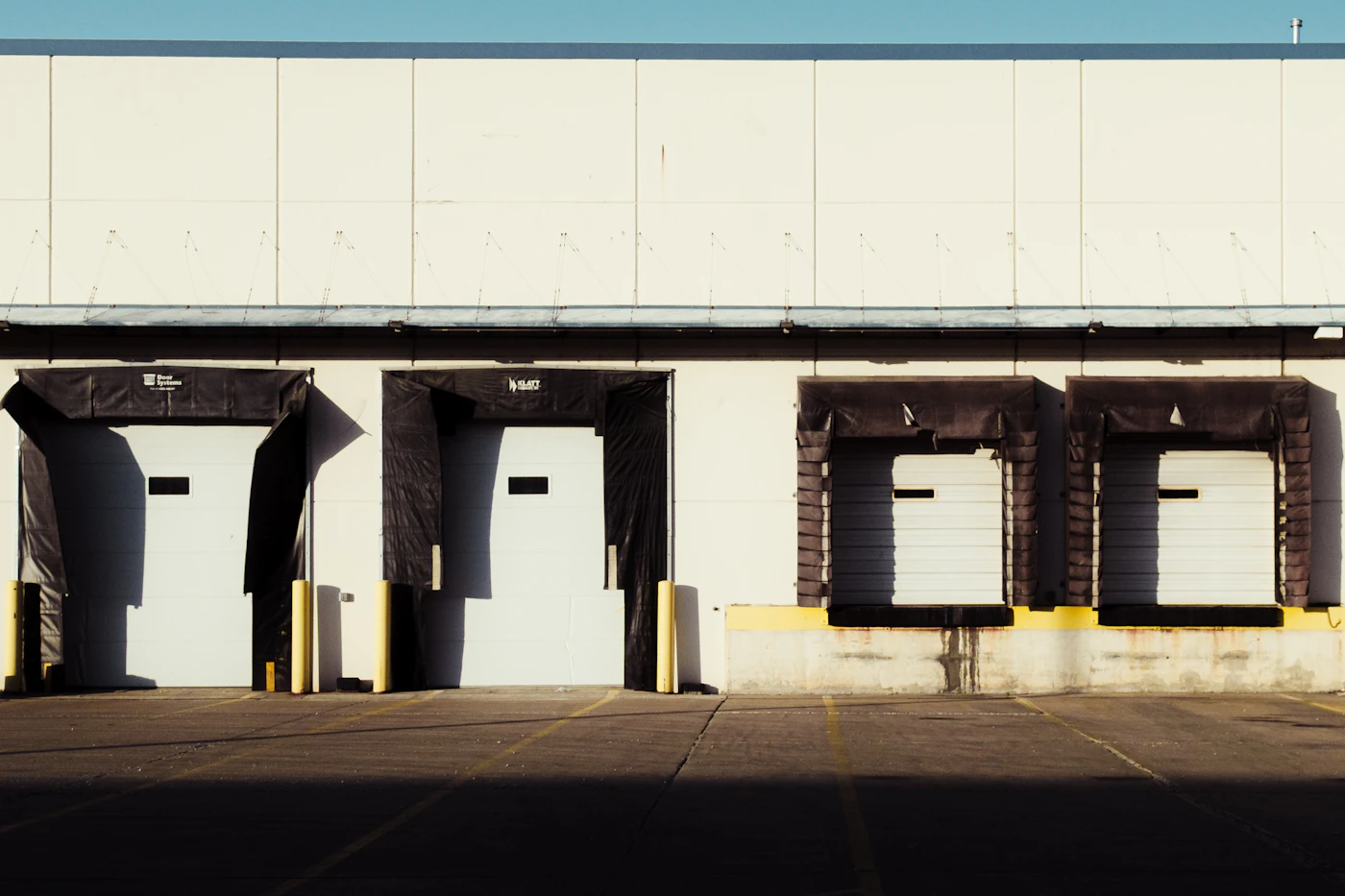 A row of loading dock doors along the side of a distribution unit